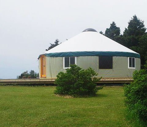 A 30 foot yurt on an open meadow in New England
